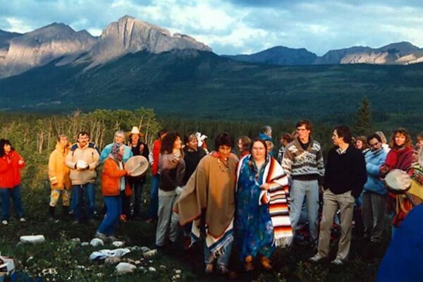 People gathered together for the harmonic conversion, Canadian rocky mountains in the distance