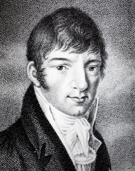 Black and white image of Martin Lichtenstein in a black high-collared jacket