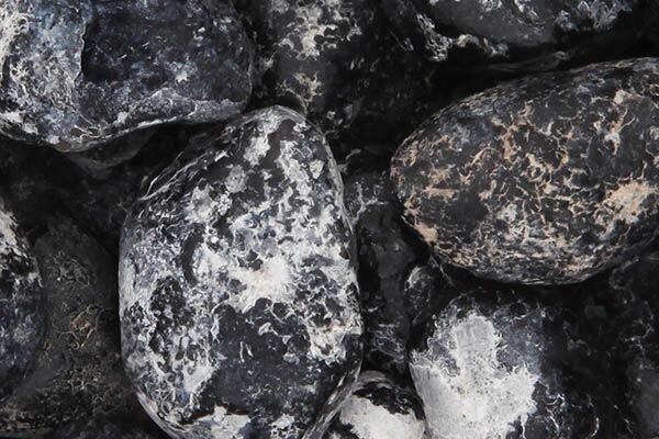 Close up of tumbled Apache Tear Obsidian