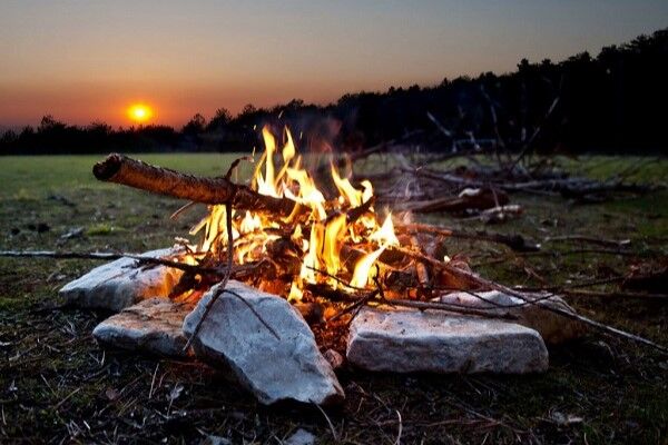 Campfire at sunset in the woods