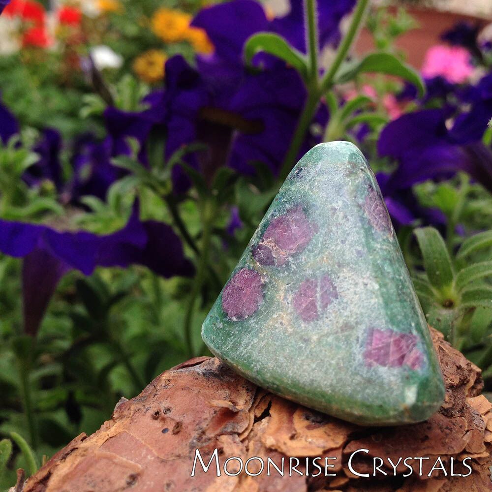 Ruby Fuchsite with colorful flowers in the background