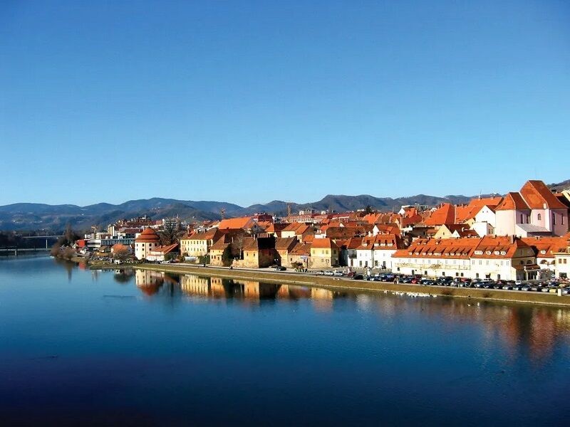 Drava-River-Maribor-Slovenia Red-roof town next to a large blue river