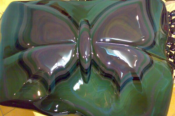 Rainbow Obsidian carved into a purple butterfly with a green background