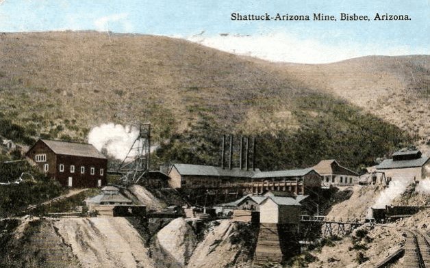 Colorized old photograph of Shattuck Mine with train track