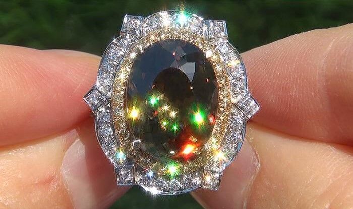 Fine Jewelry Demantoid Garnet ring with a diamond halo