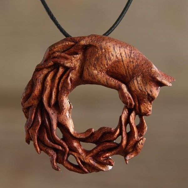 Mahogany Wood carving of a fox chasing its fiery tail