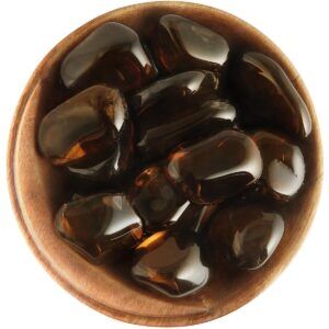 Bowl of tumbled Smoky Quartz. Irregularly shaped polished stones, dark brown and transparent