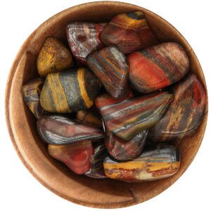 Bowl of tumbled Tiger Iron. Irregular polished shapes. Each stone is striped red, yellow, and silver.