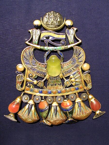 Colorful pendent, in the center is a yellow-green Libyan Desert Glass carved into a scarab