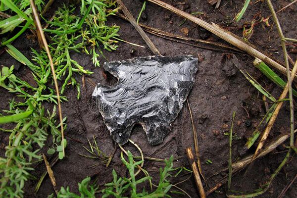 Obsidian arrowhead on the ground